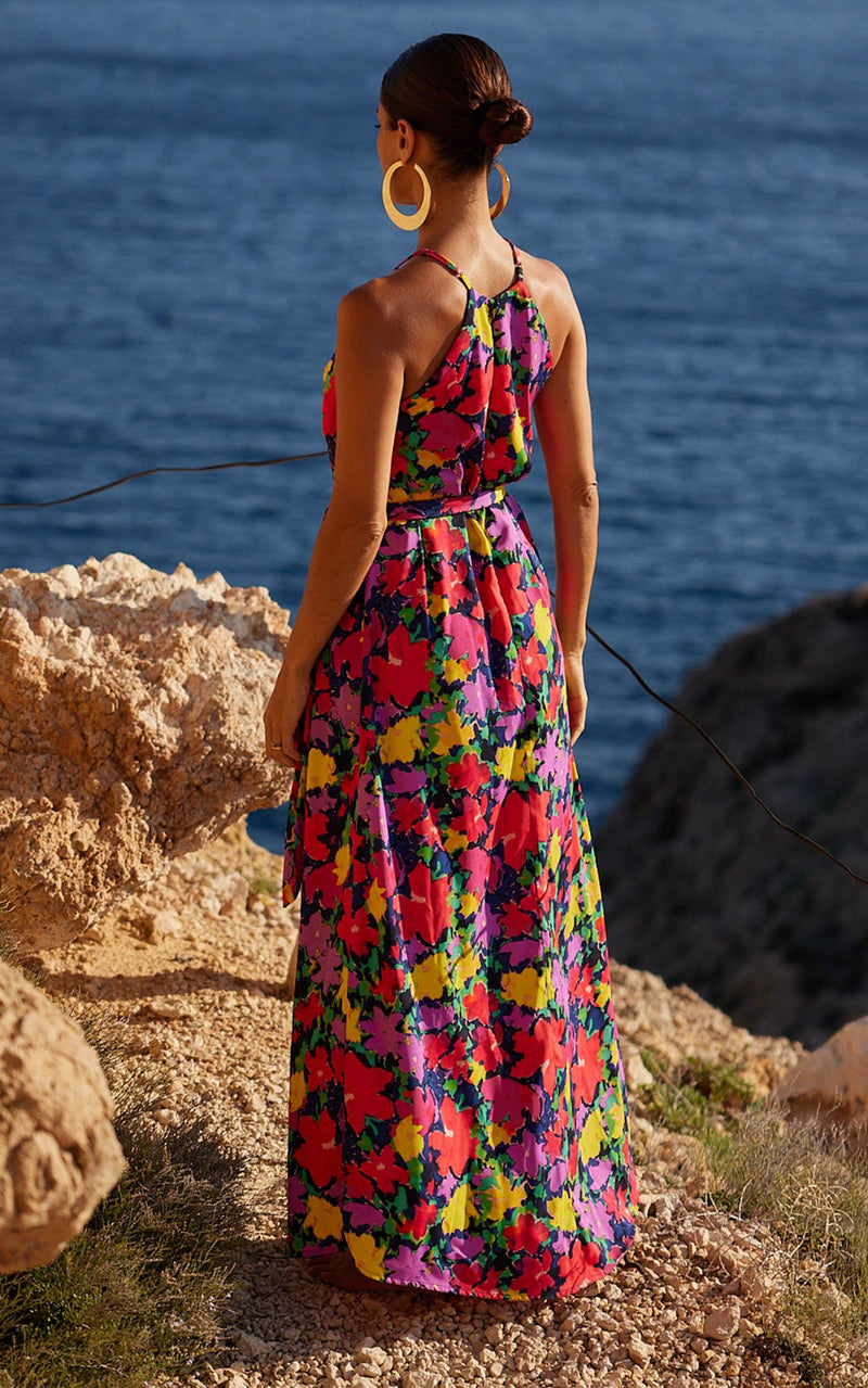 A female model faces backwards. She wears a Dancing Leopard colourful, floral printed dress.