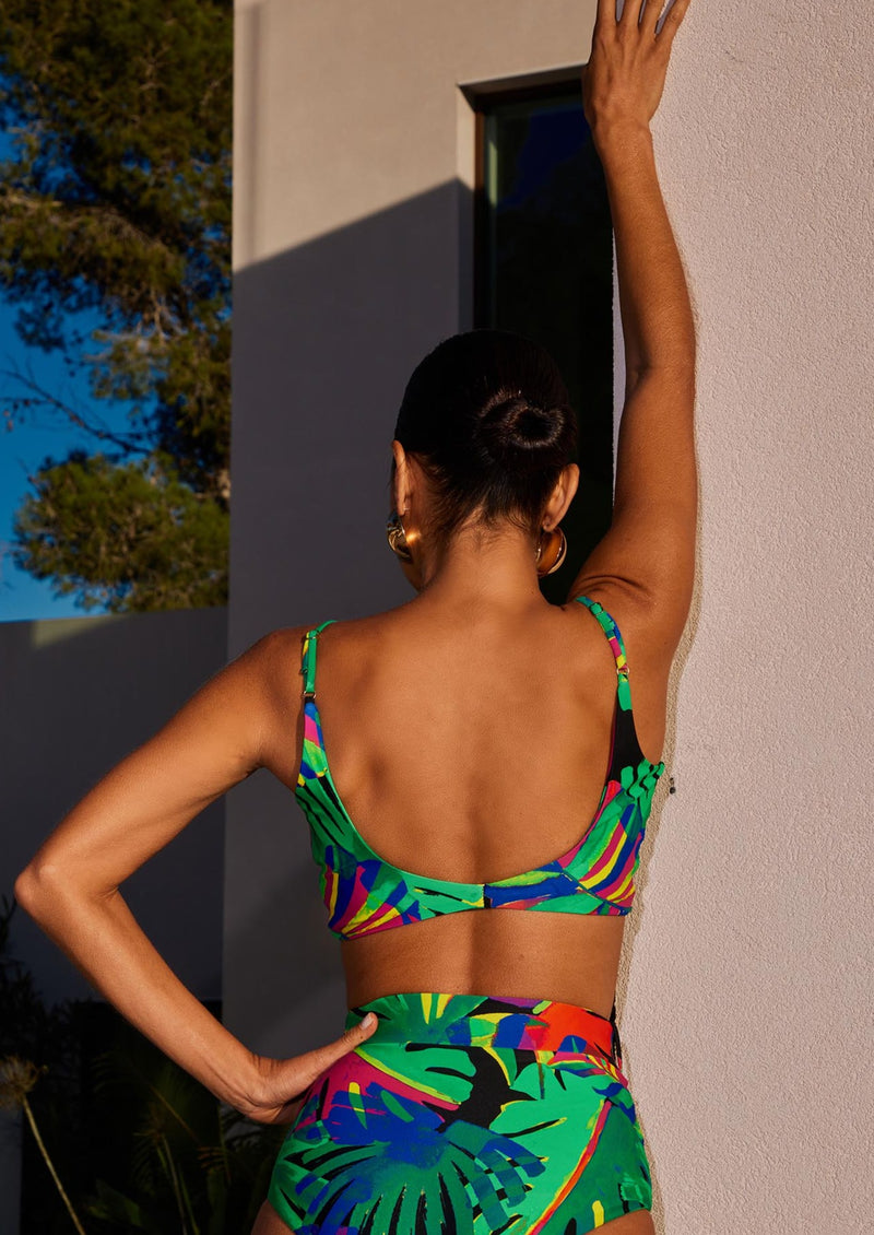 Female model faces backwards. She wears a Dancing Leopard tropical print bikini top with matching bikini bottoms.