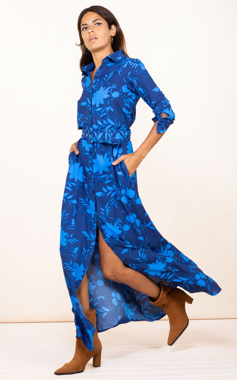 Dancing Leopard model walks forwards with hands on hips wearing Dove Dress in Dark Blue Silhouette Ground