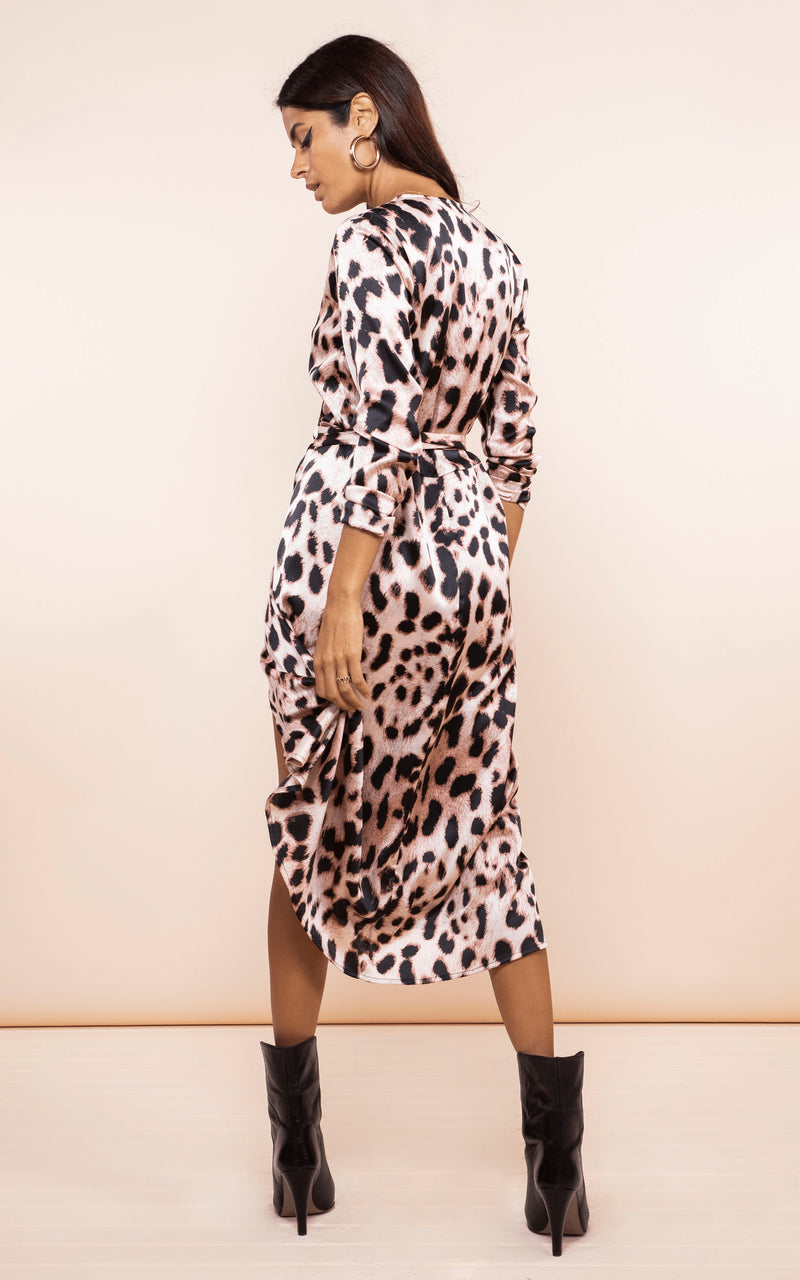 Backward-facing model wears Dancing Leopard Yondal Dress in blush leopard print with boots