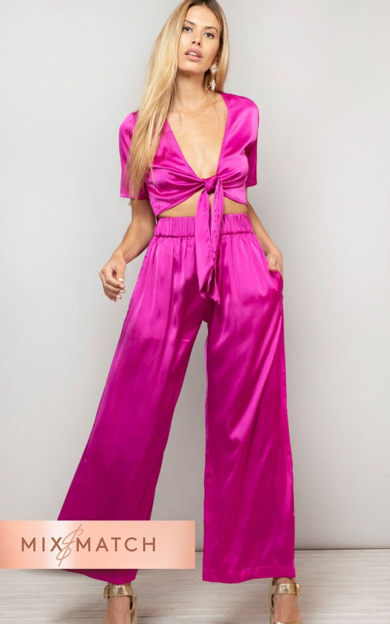 Front-facing model with hand in pocket wears Chinchilla Trousers in magenta pink by Dancing Leopard