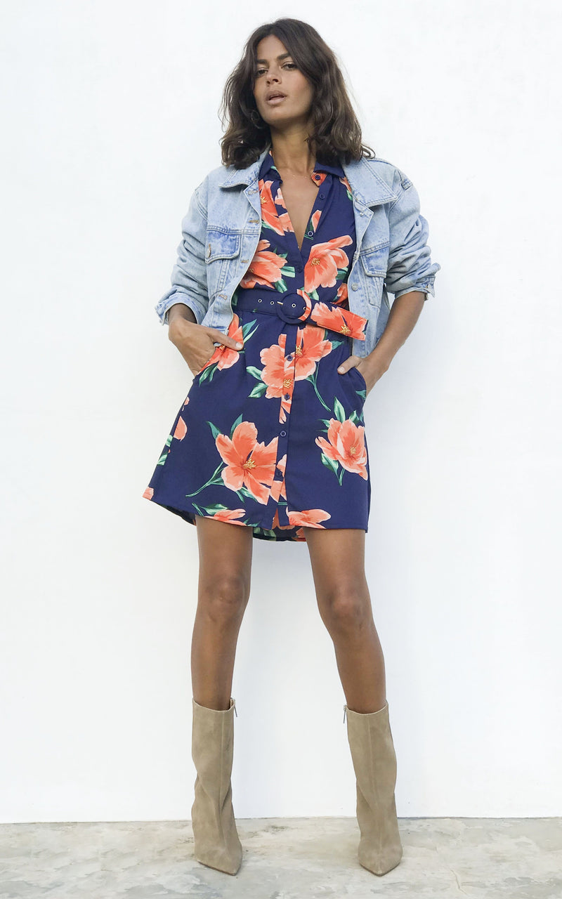 Model wears Dancing Leopard Jonah dress in orange on navy tulip with cream ankle boots and denim jacket