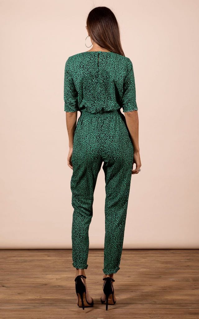 Model faces backwards wearing Zion Jumpsuit in green leopard print by Dancing Leopard